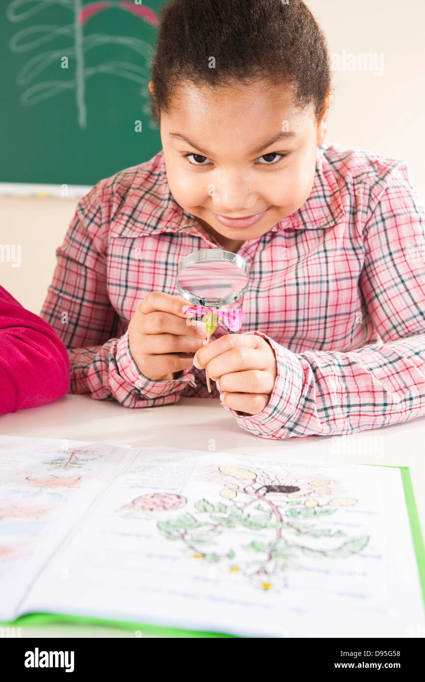 Portrait of Girl Looking at Flower in Classroom, Baden-Wurttemberg, Germany Stock Photo