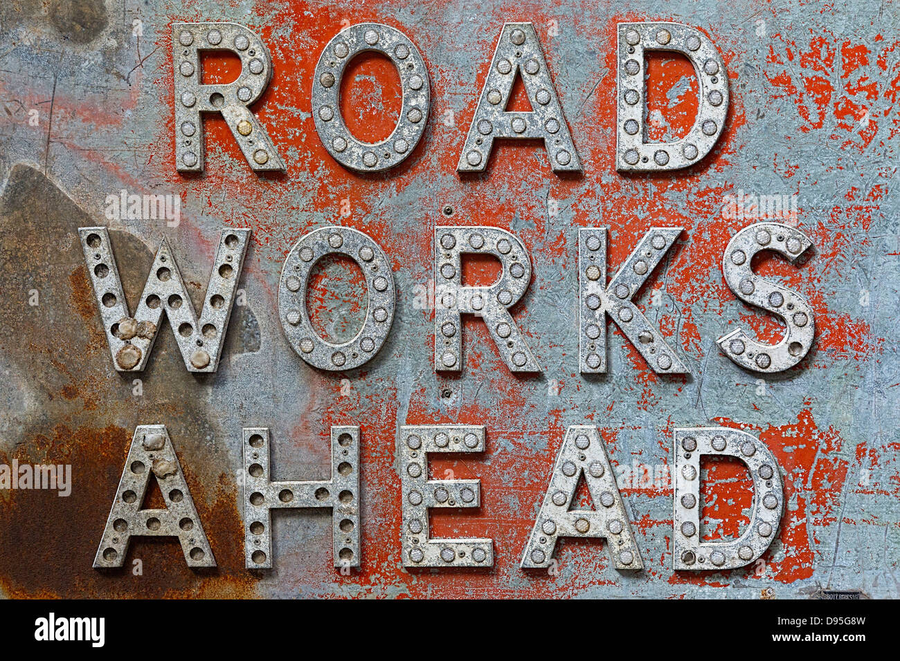 Mid to late C20 sheet metal enamel sign with raised lettering and light relectors. Road works Ahead. Stock Photo