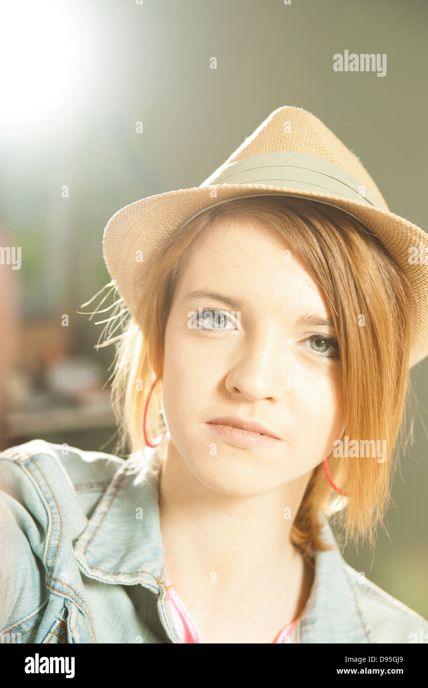 Head and shoulders portrait of teenage girl wearing hat in studio Stock ...