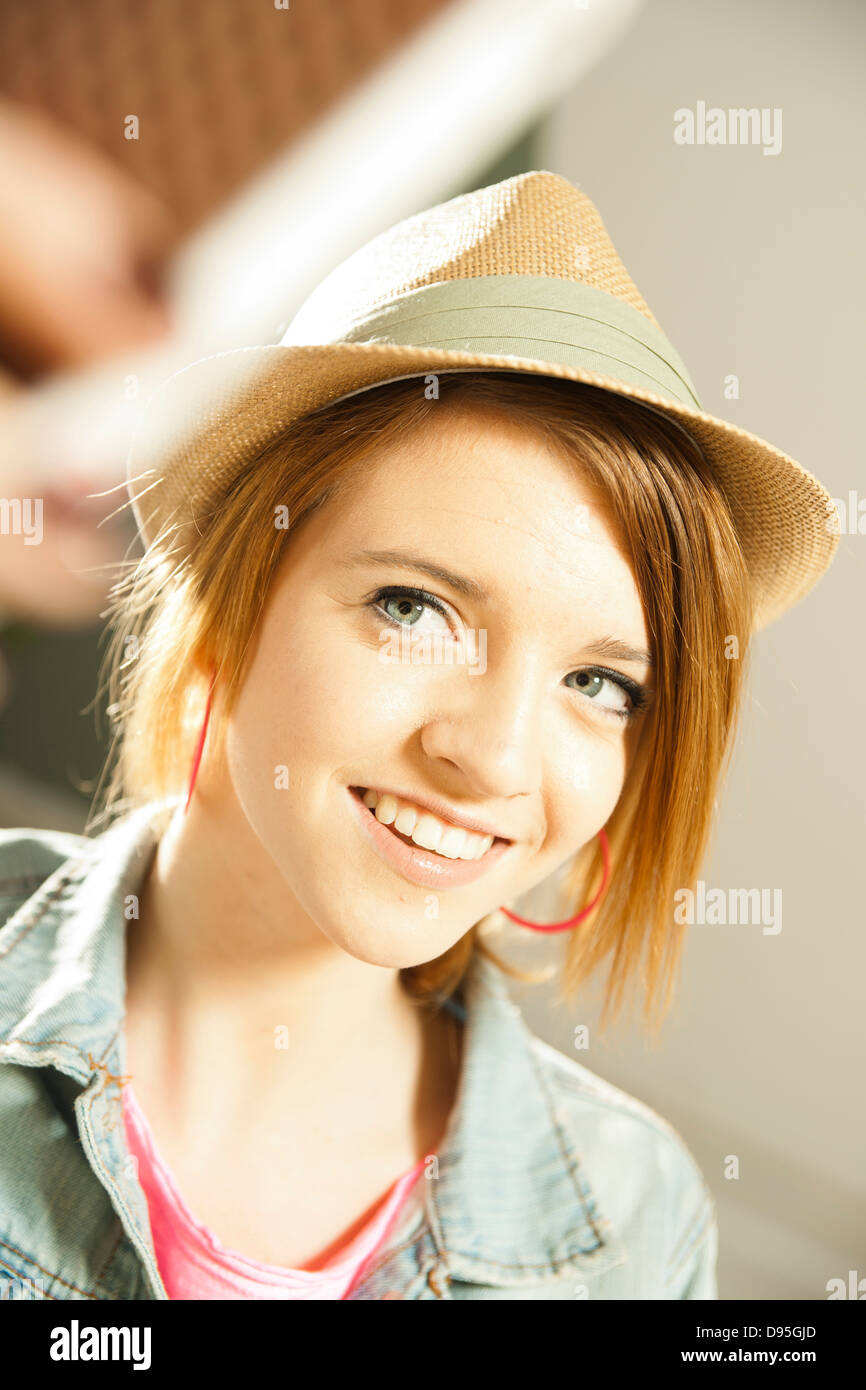 Head and shoulders portrait of teenage girl wearing hat in studio Stock Photo Alamy