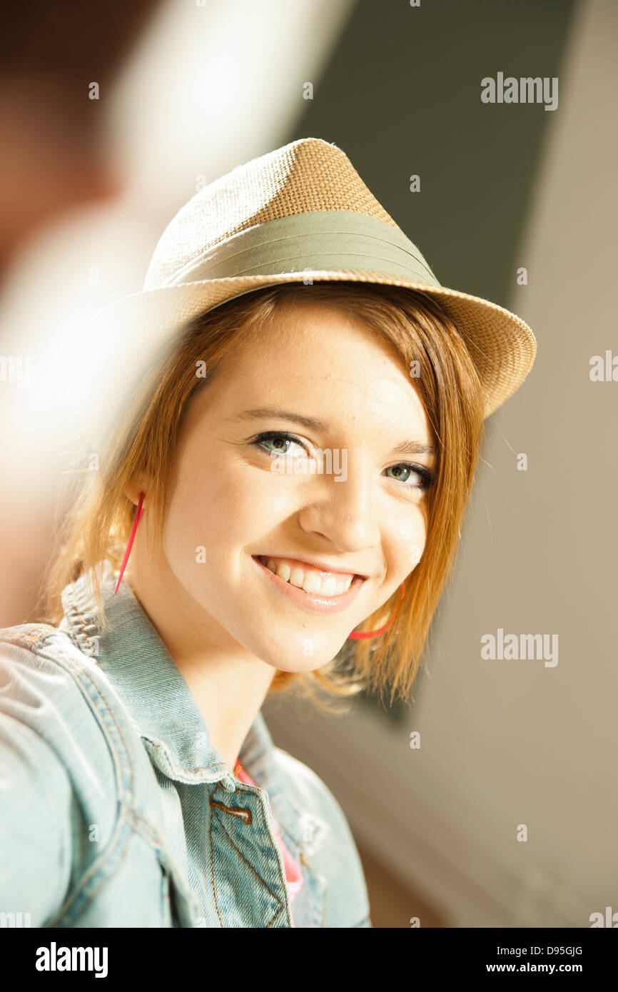 Head and shoulders portrait of teenage girl wearing hat in studio Stock ...