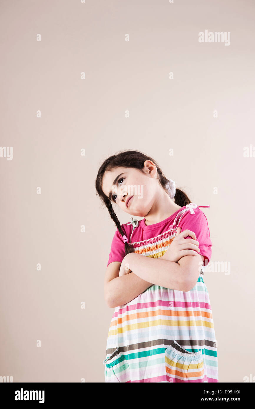 Portrait of Girl with Arms Crossed in Studio Stock Photo