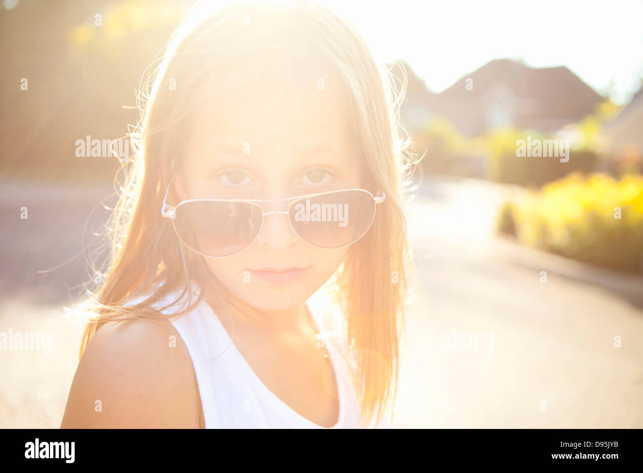 Portrait of young girl wearing aviator sunglasses on a sunny summer