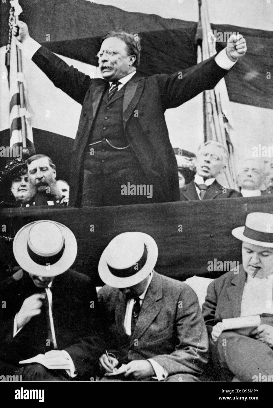 Theodore Roosevelt (1858-1919) President of USA 1901-1912 making a speech. In foreground, reporters are making notes. Stock Photo