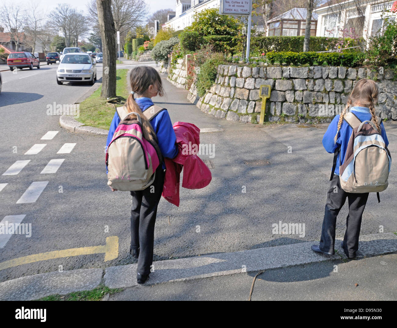 Two sisters returning from school and waiting to cross the road. Image shot 2009. Exact date unknown. Stock Photo