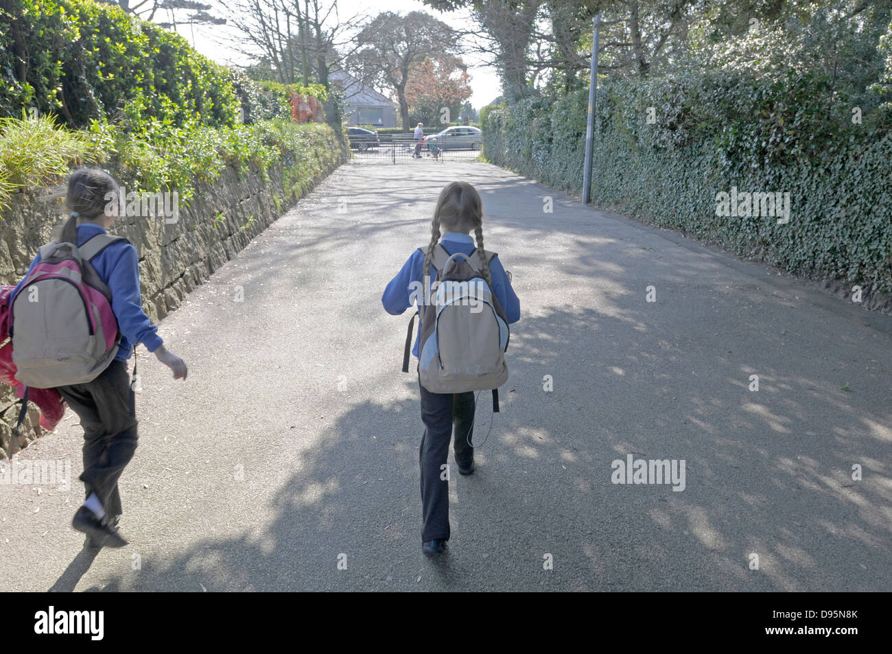 Two sisters returning from school.. Stock Photo