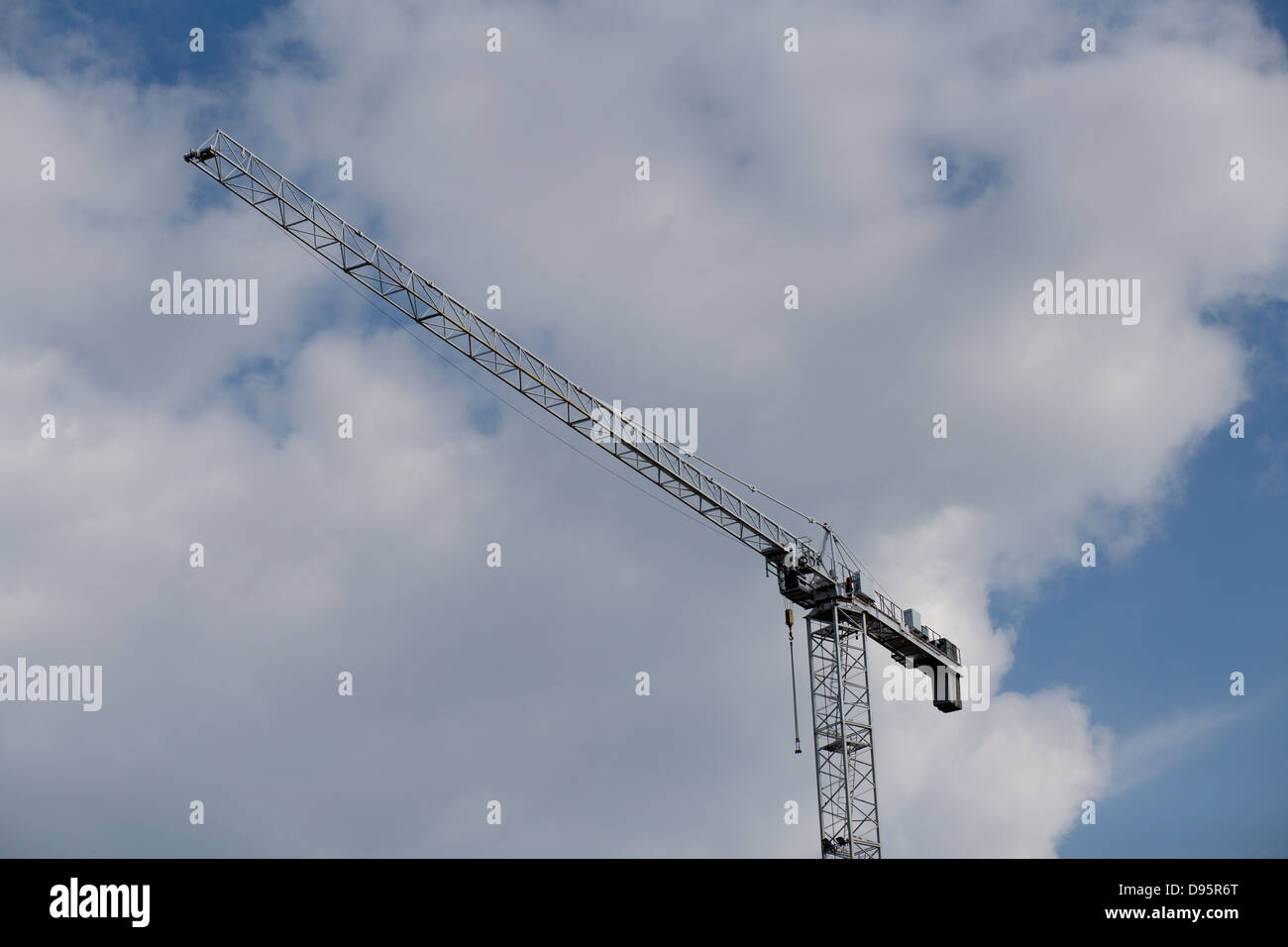 Construction cranes in operation. On the background a dramatic sky. Stock Photo