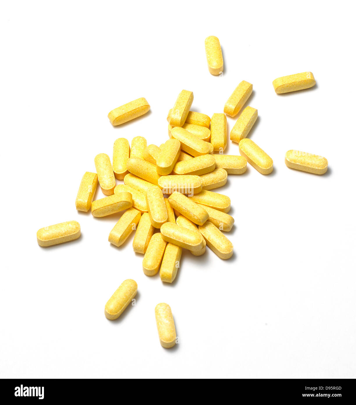 yellow pills cut out onto a white background Stock Photo