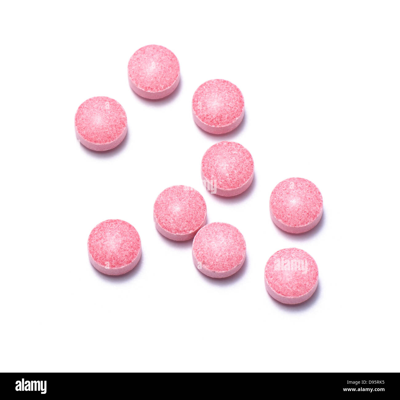 pink pills cut out onto a white background Stock Photo