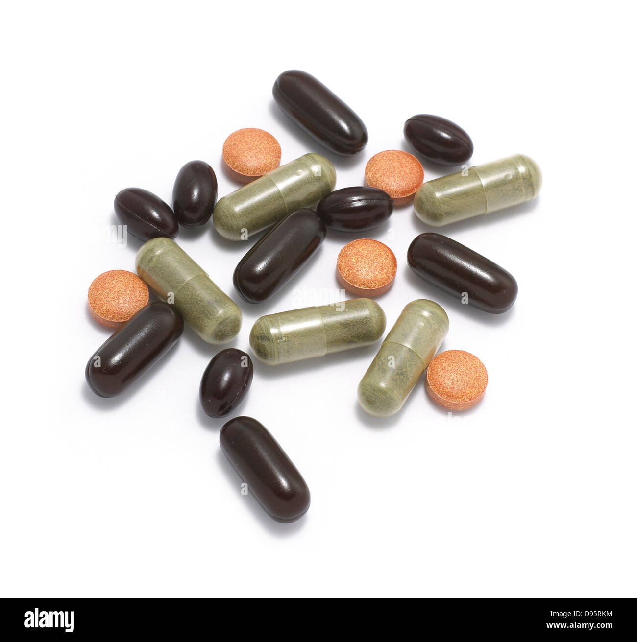 mixed pills and capsules cut out onto a white background Stock Photo