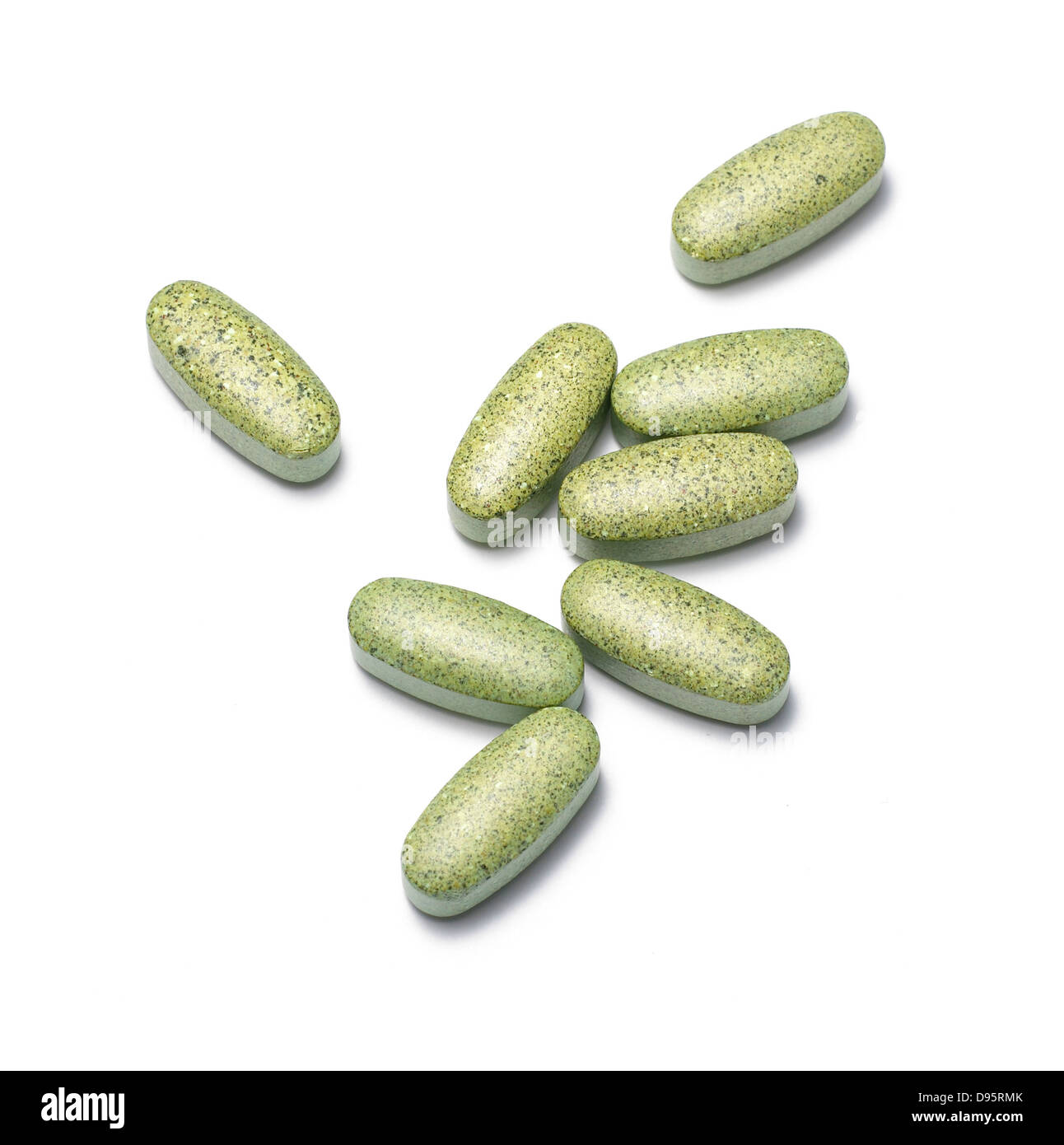 green vitamins cut out onto a white background Stock Photo