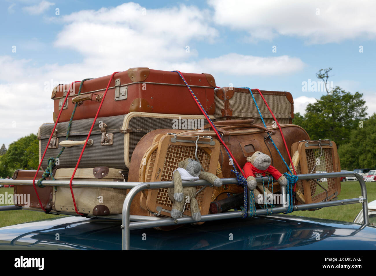 Old style fashioned luggage suitcases on car roof rack 