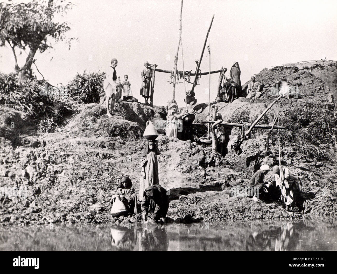 A shaduf or shadoof being used to raise water, Egypt, late 1880s. The shaduf has been used for irrigation for at least as early as 1500 BC. Photograph. Water supply. Agriculture. Stock Photo