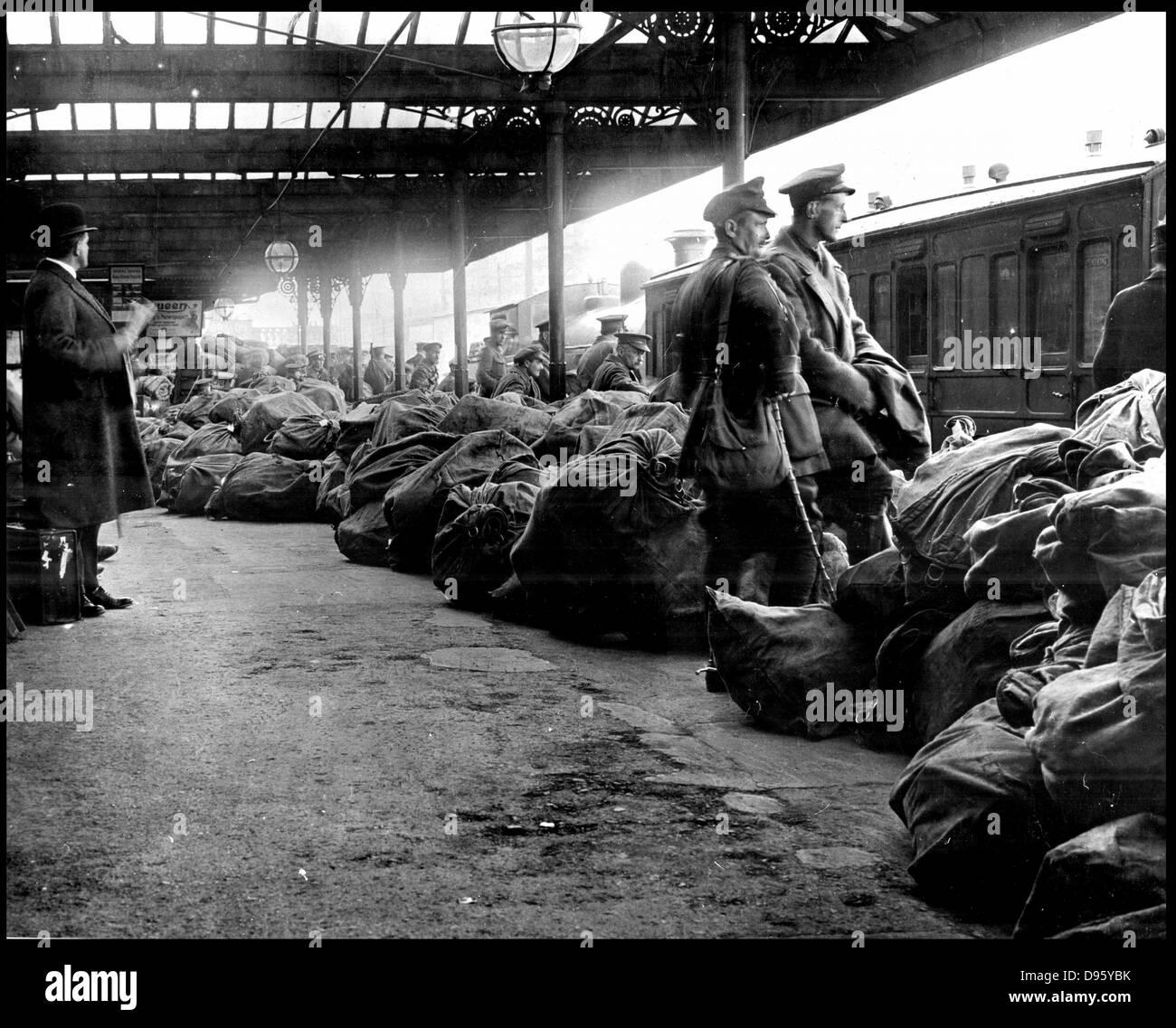 After the anti-English Irish uprising in Dublin, May 1916, public services were disrupted.  Here sacks of mail are piled up on the platform at Dublin station under the guard of British troops, awaiting distributiion. Photograph. Stock Photo