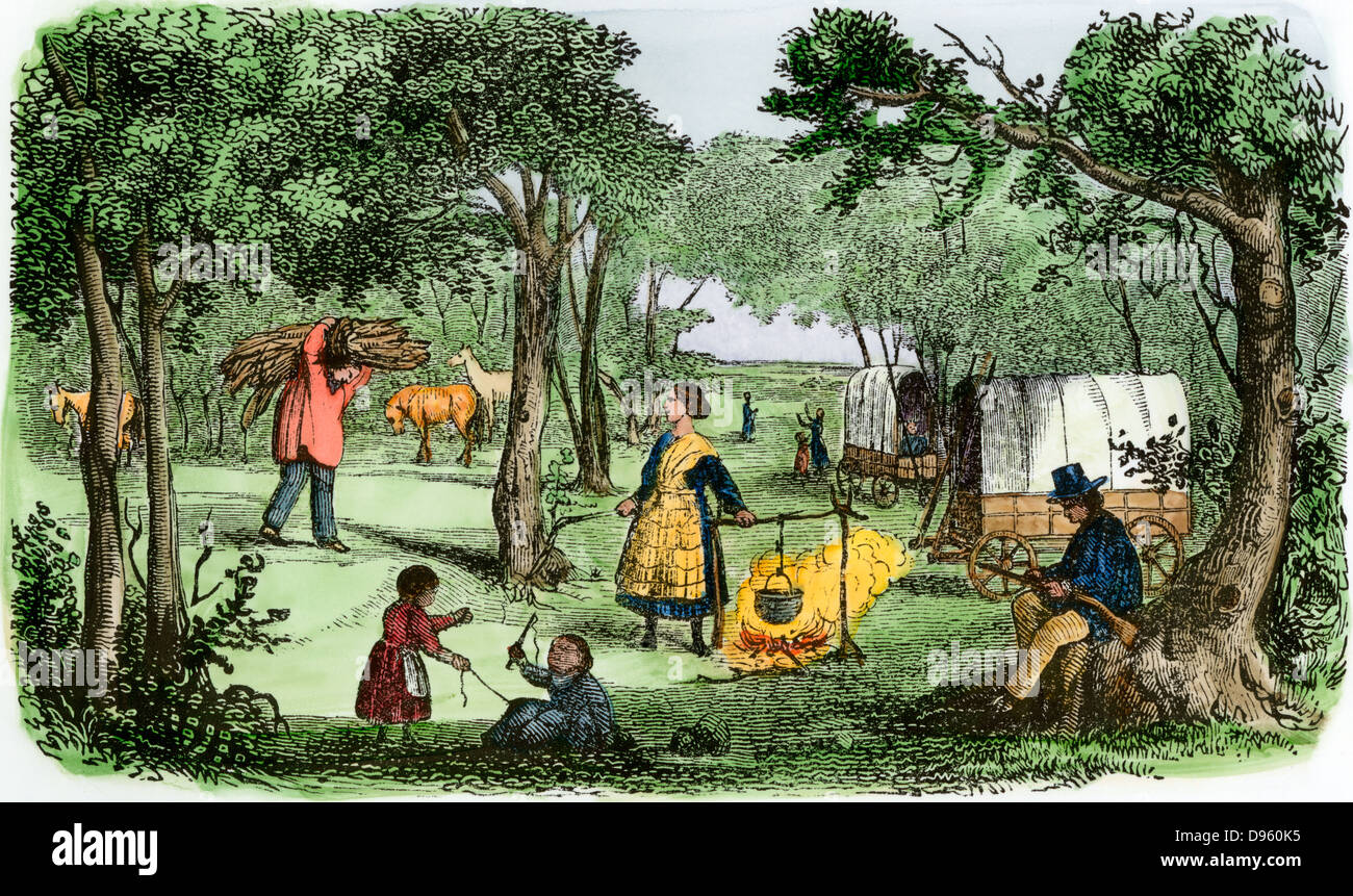 Pioneers' camp at sunset along the Oregon Trail, 1850s. Hand-colored woodcut Stock Photo