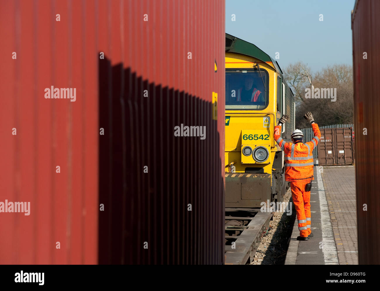 Workers working in a rail freight depot in England. Stock Photo