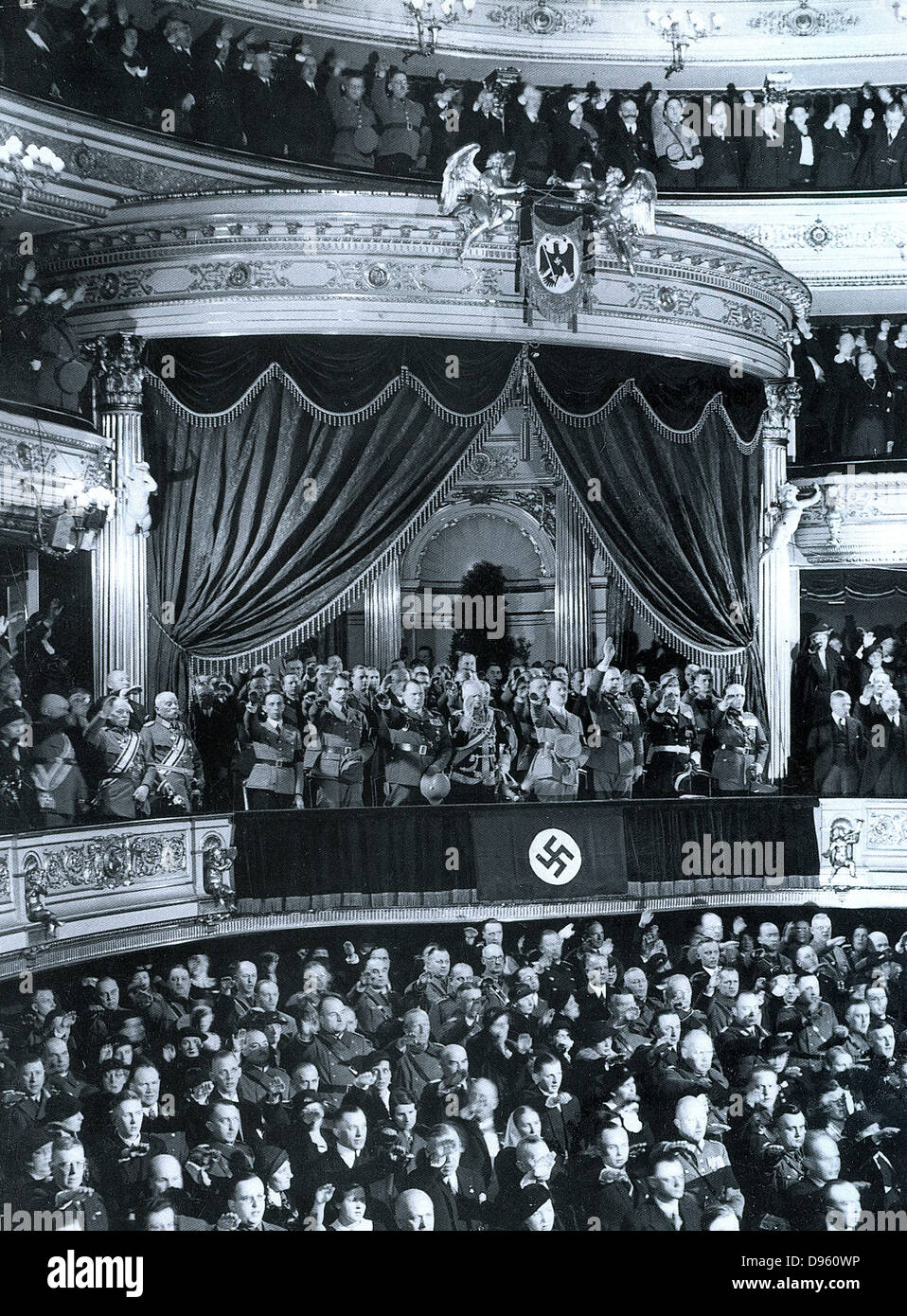 Chancellor Adolf Hitler is greeted by an audience in a theatre in Germany c1935. Key Nazi leaders attending are seen in the State Official Box. Left to right: Josef Goebbels, Rudolf Hess, Herman Göring, Field Marshall Von Mackensen, Adolf Hitler, General Stock Photo