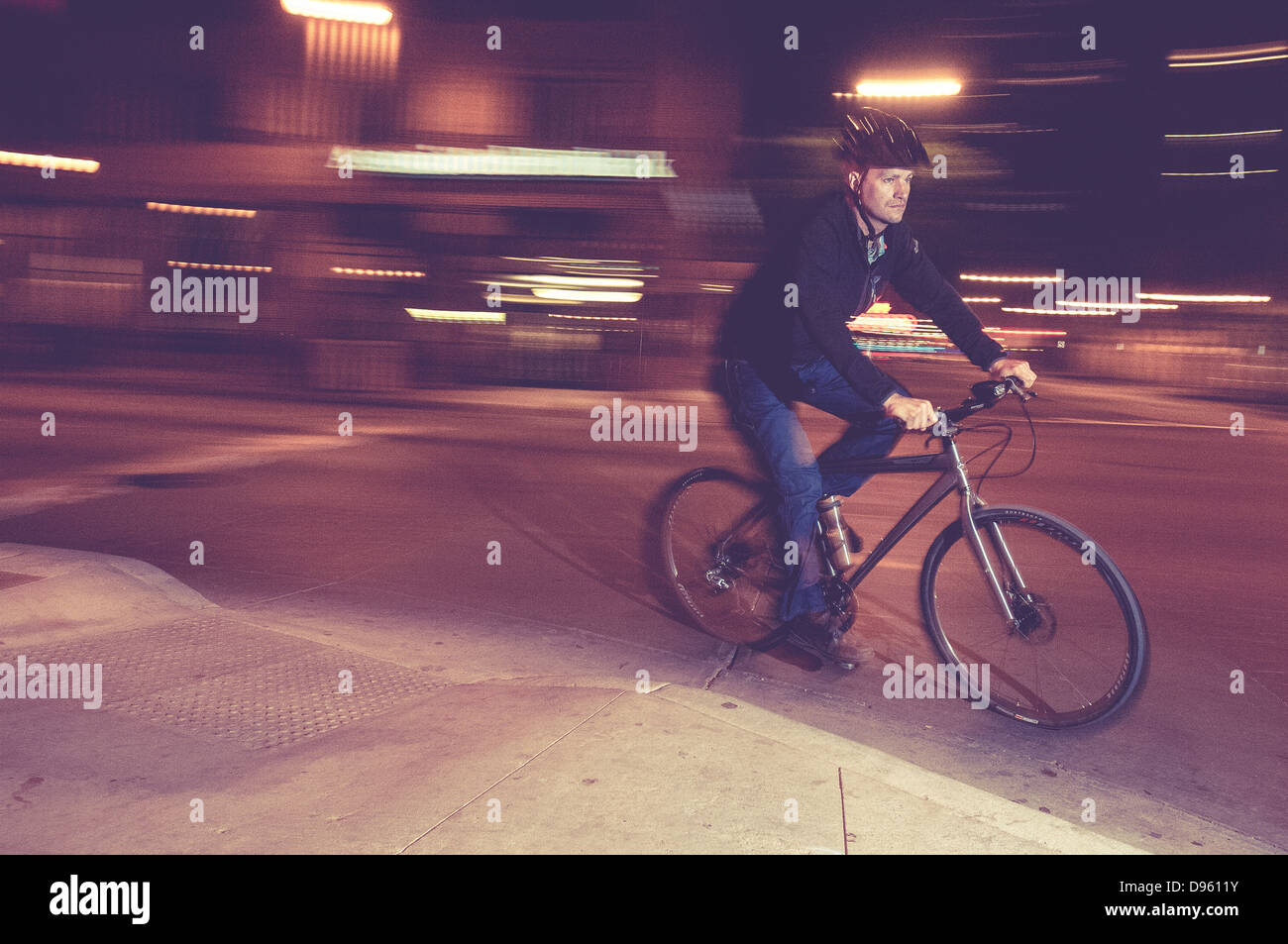 Bicycle commuter riding at night Stock Photo Alamy