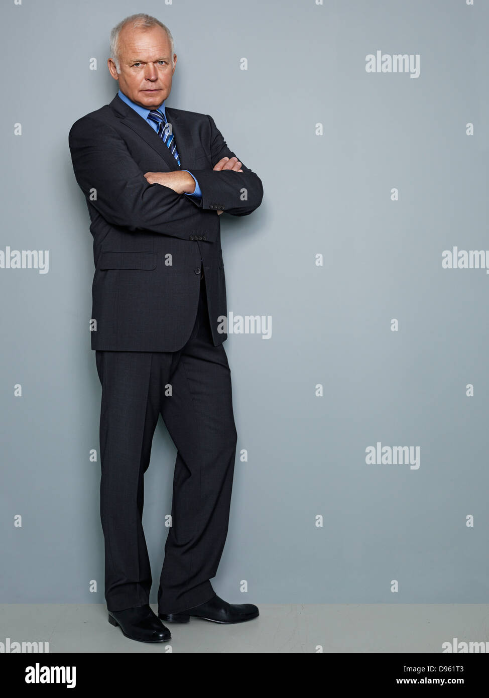 Portrait of businessman standing with arms crossed Stock Photo - Alamy