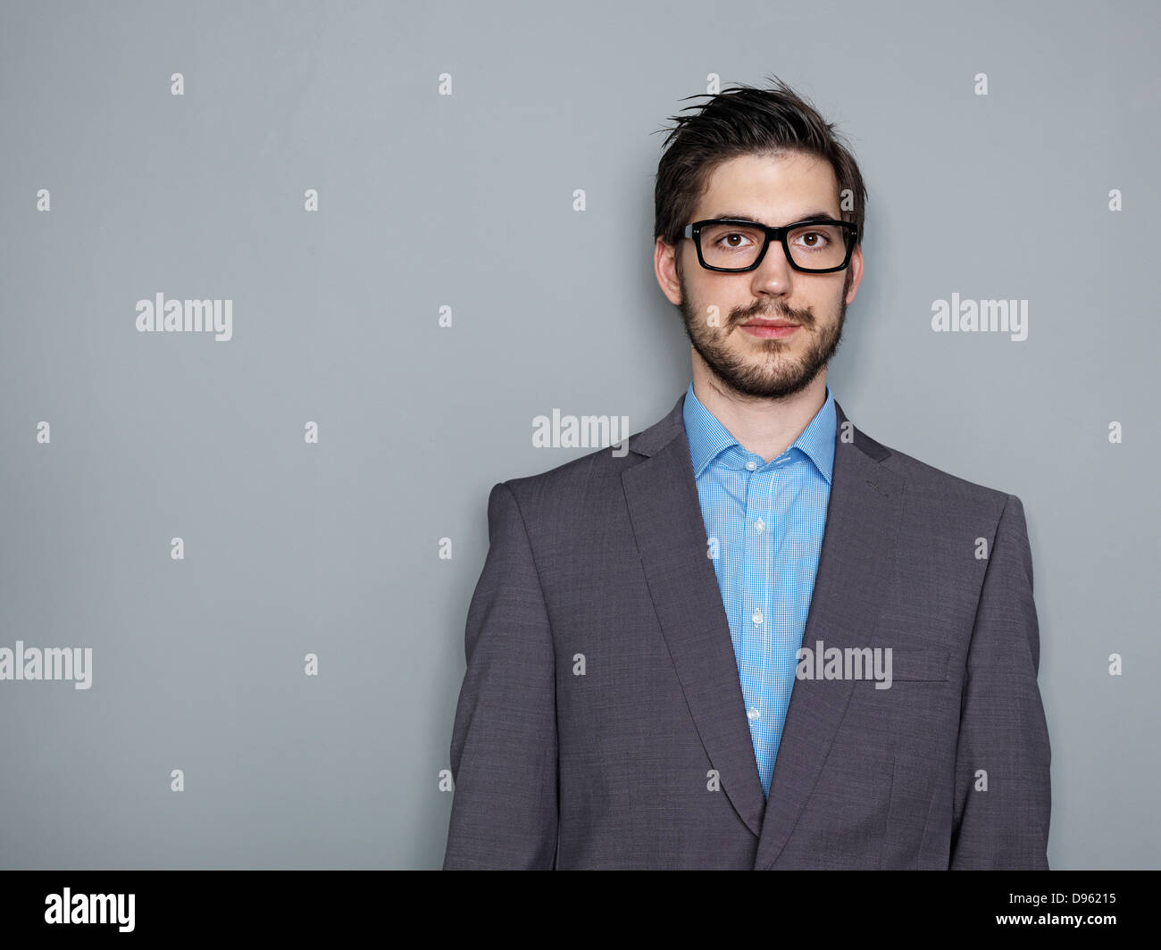 Portrait of businessman against grey background Stock Photo - Alamy