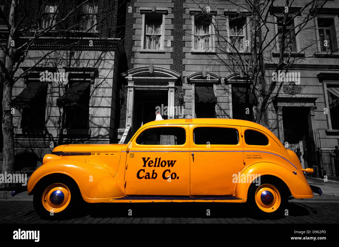 Side view of vintage Yellow Cab co. car parked outside faux period buildings at Universal Studios theme park, Florida, USA. Selective colour. Stock Photo
