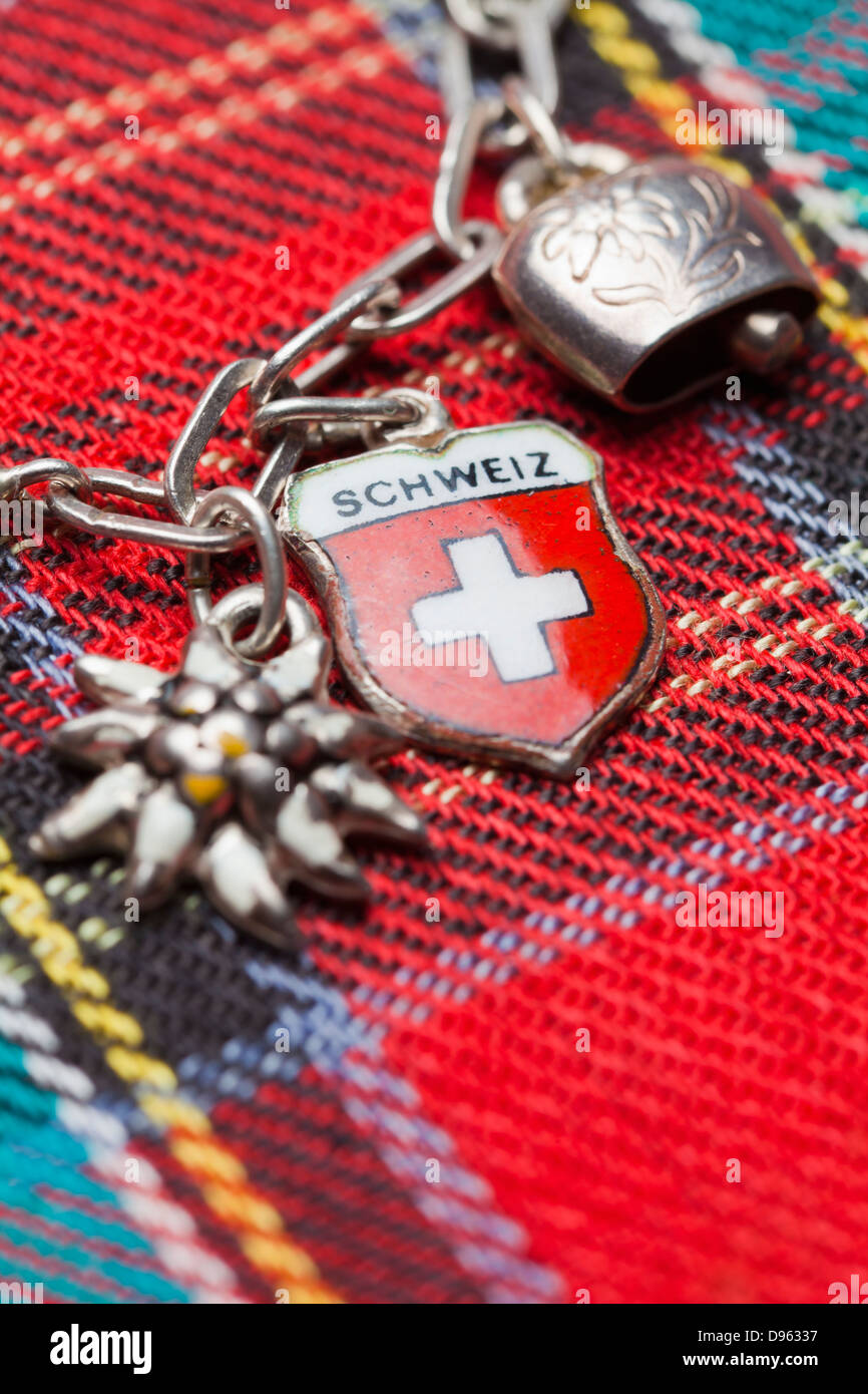 Switzerland, Swiss flag on charm bracelet with cow bell and edelweiss Stock  Photo - Alamy