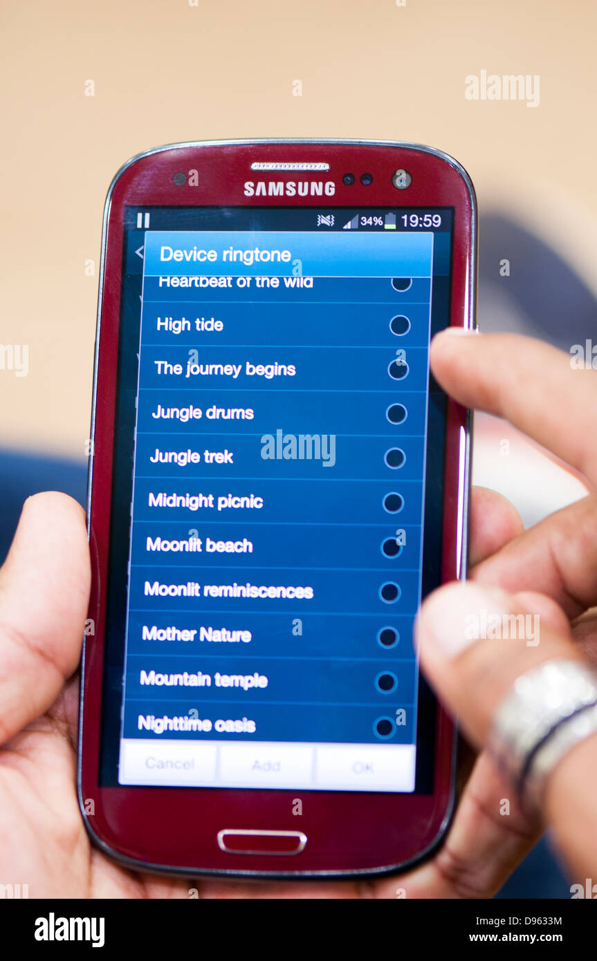 Setting ringtone on cell phone Stock Photo - Alamy