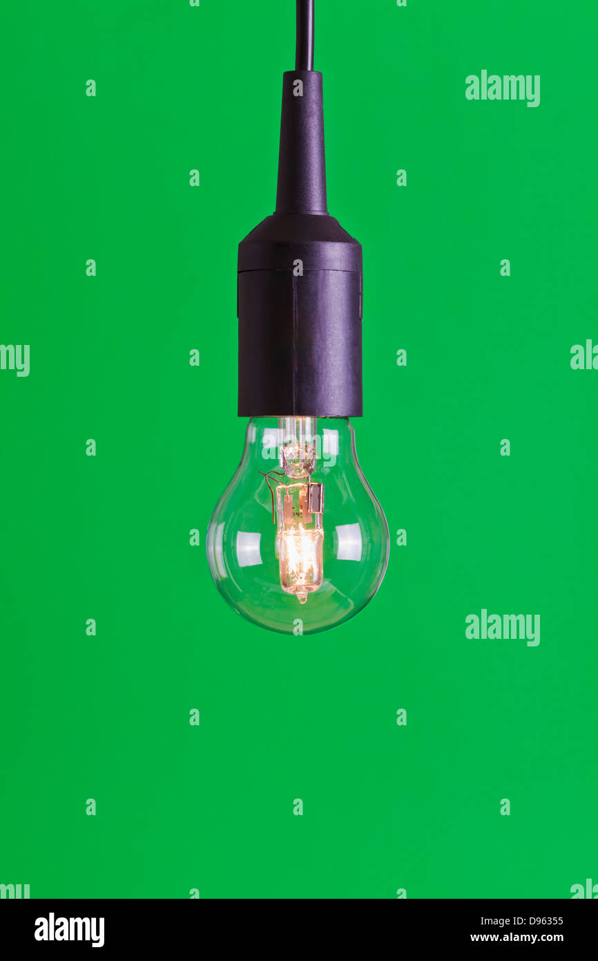 Halogen bulb against green background Stock Photo