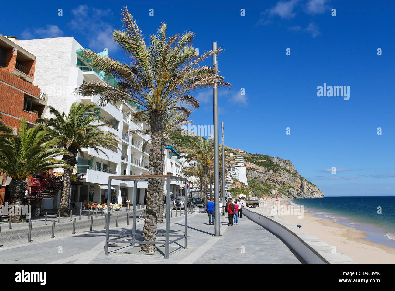 Unidentified people walking on the promenade near the beach and the Atlantic coast of Sesimbra, Portugal on May 27, 2013. Stock Photo