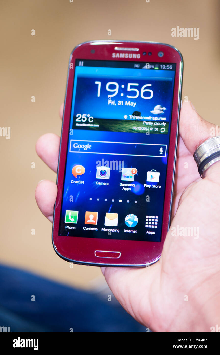 Hand holding Samsung S3 smartphone, close up Stock Photo