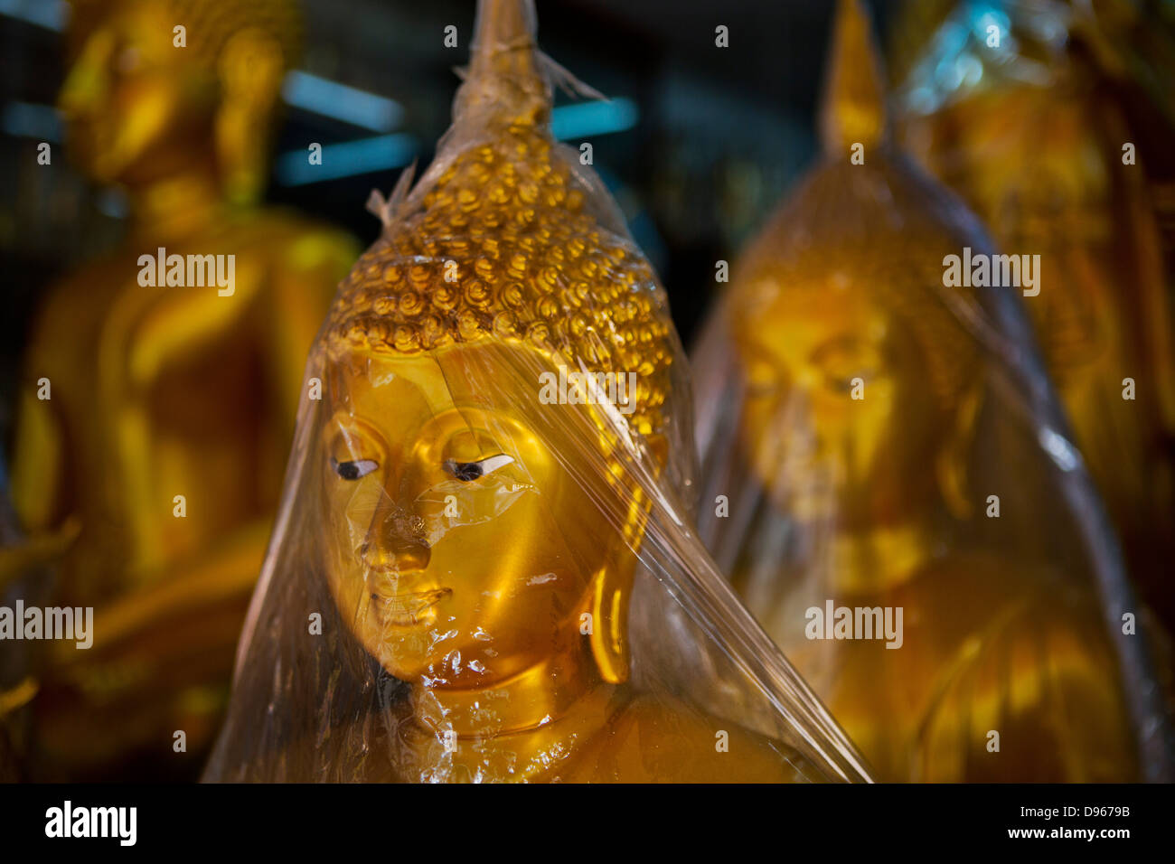 Covered buddhas for sale in shops situated in the heart of Bangkok Stock Photo
