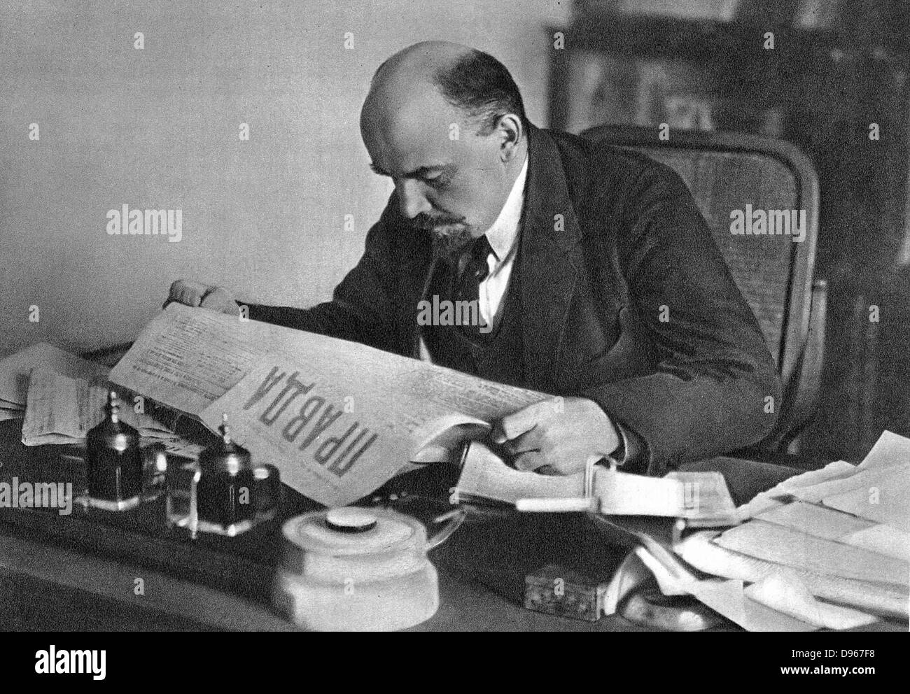 Vladimir Ilyich Lenin (Ulyanov 1870-1924) reading 'Pravda' 1918. Russian revolutionary. Stock Photo