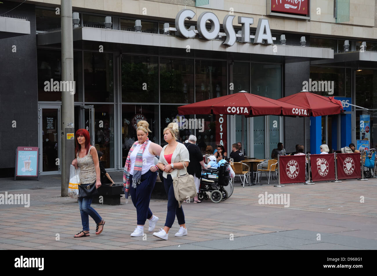 Three women walking past Costa coffee shop in St Enoch Square, Glasgow, Scotland, UK Stock Photo