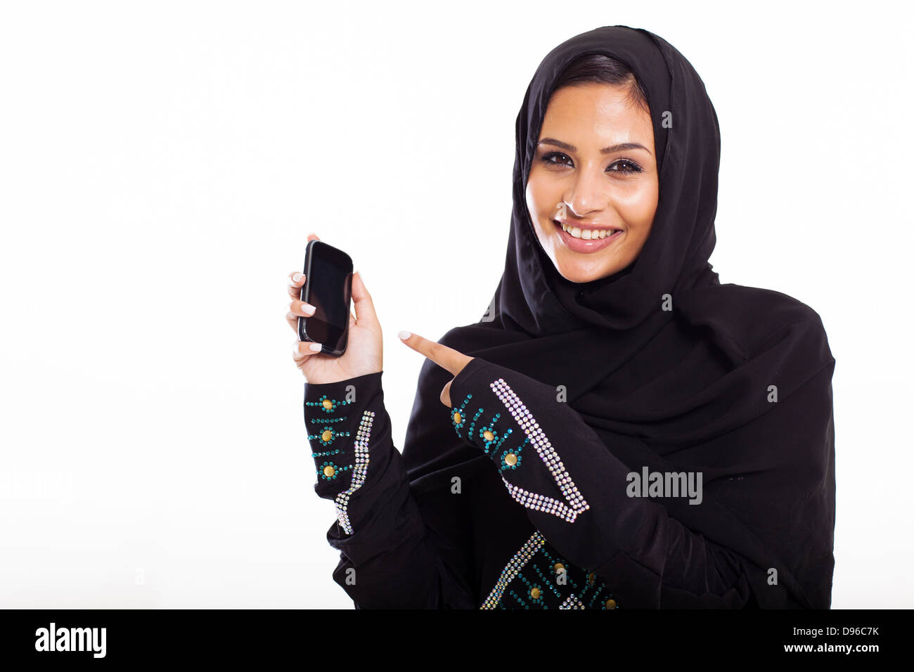 young middle eastern woman pointing at smart phone isolated on white Stock Photo