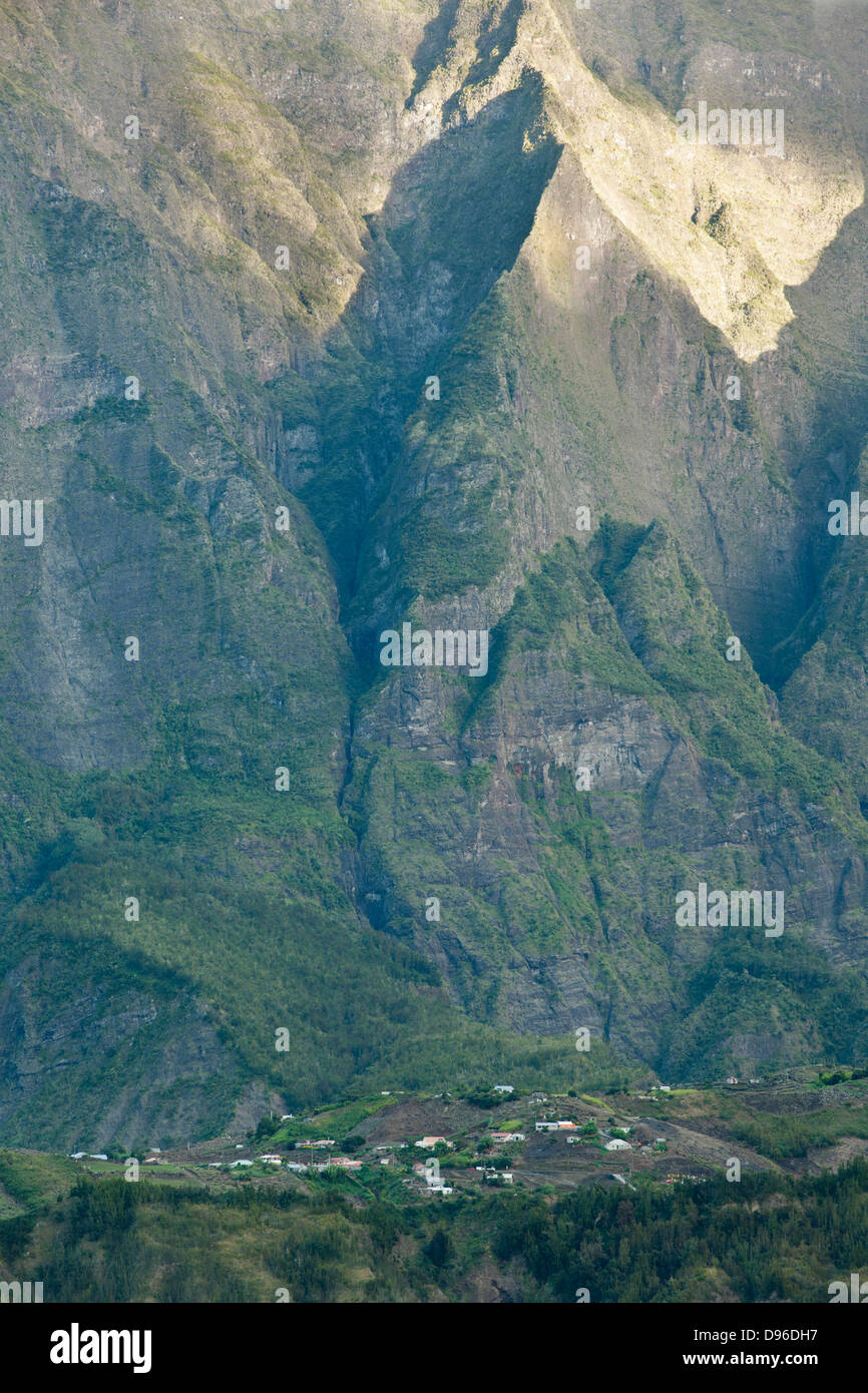 Village nestled at the foot of the mountains encircling the Cirque de Cilaos caldera on the French island of Reunion. Stock Photo