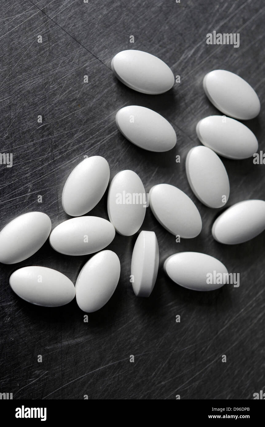 vitamin tablets on steel bench Stock Photo