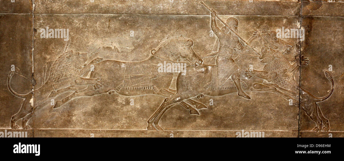 Lion hunt on horseback. Wall fragment depicting King Ashurbanipal and his attendants hunting lions. Assyrian, circa 645-635 BC. From the North Palace in Nineveh. Stock Photo
