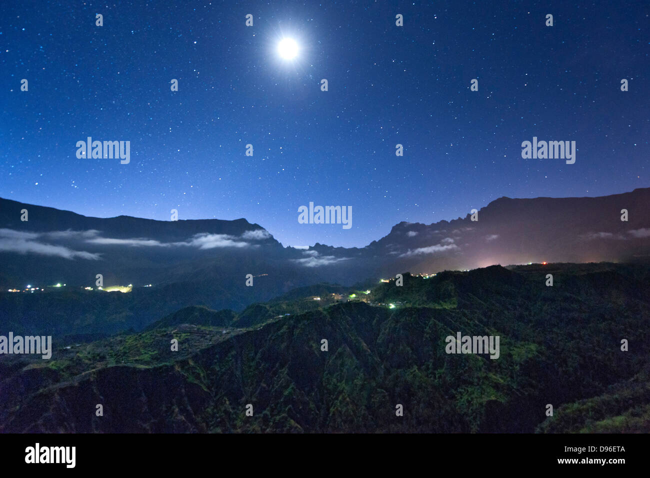 Night view of stars and the moon above the Cirque de Cilaos caldera on the French island of Reunion in the Indian Ocean. Stock Photo