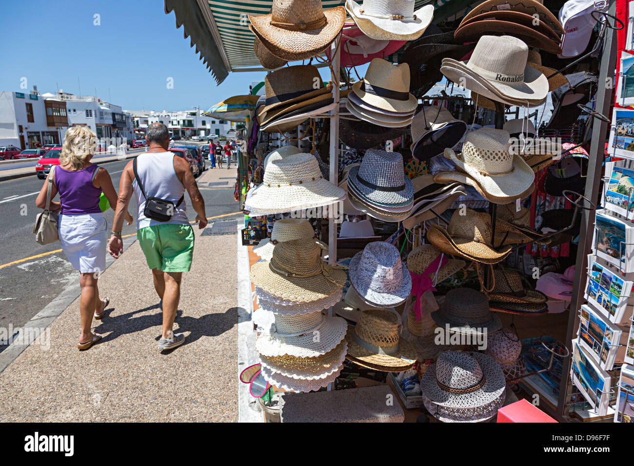 Hats on sale in tourist shop on beach front, Playa Blanca, Lanzarote, Canary Islands, Spain Stock Photo