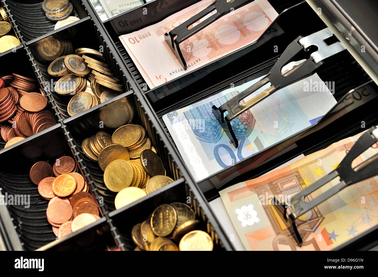 Euro banknotes and coins in a cashbox. Stock Photo