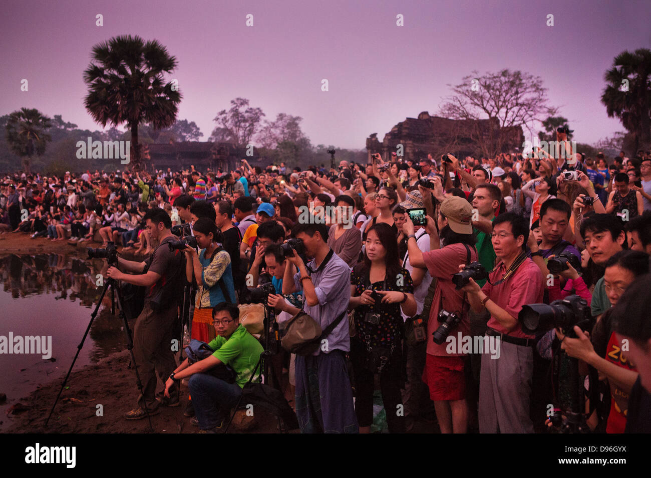 Tourists photographing the dawn at the buddhist temple Angkor Wat, , Cambodia Stock Photo
