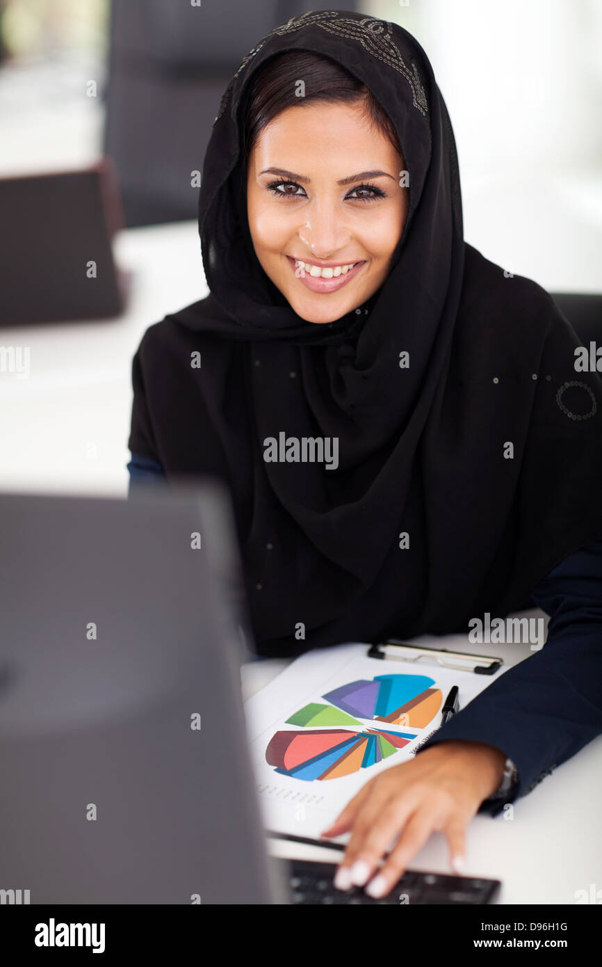 attractive female Arabic office worker in office Stock Photo