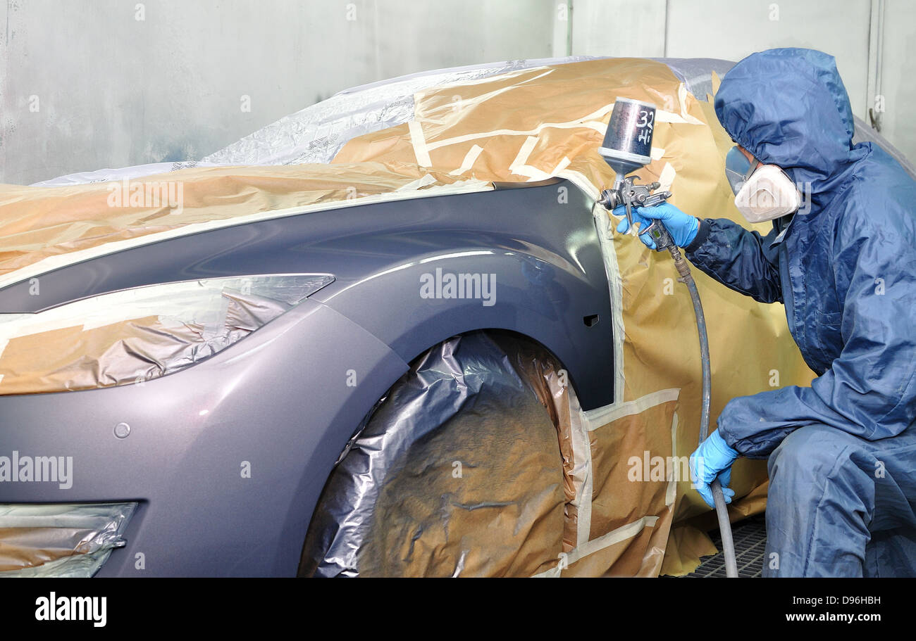 Worker painting car in a paint booth Stock Photo Alamy