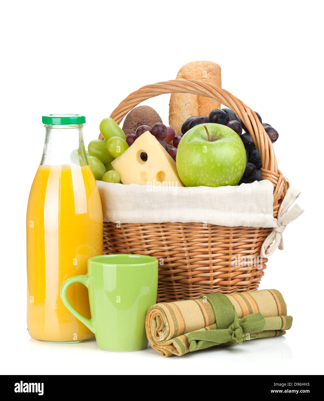 Picnic basket with bread, fruits and orange juice bottle. Isolated on white background Stock Photo
