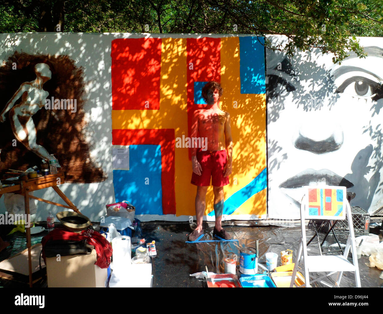 Artists work on their canvas' at the Howl! Festival's 'Art Around the Park' around Tompkins Square Park in NY's East Village Stock Photo