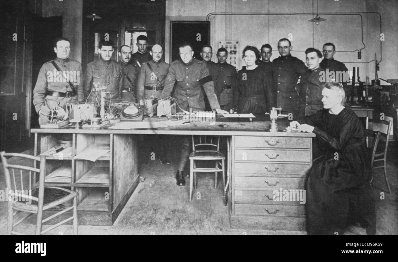 Marie Curie (1867-1934) Polish-born French physicist, and her daughter Irene, with pupils from the American Expeditionary Corps at the Institute of Radium, Paris, in 1919. Stock Photo