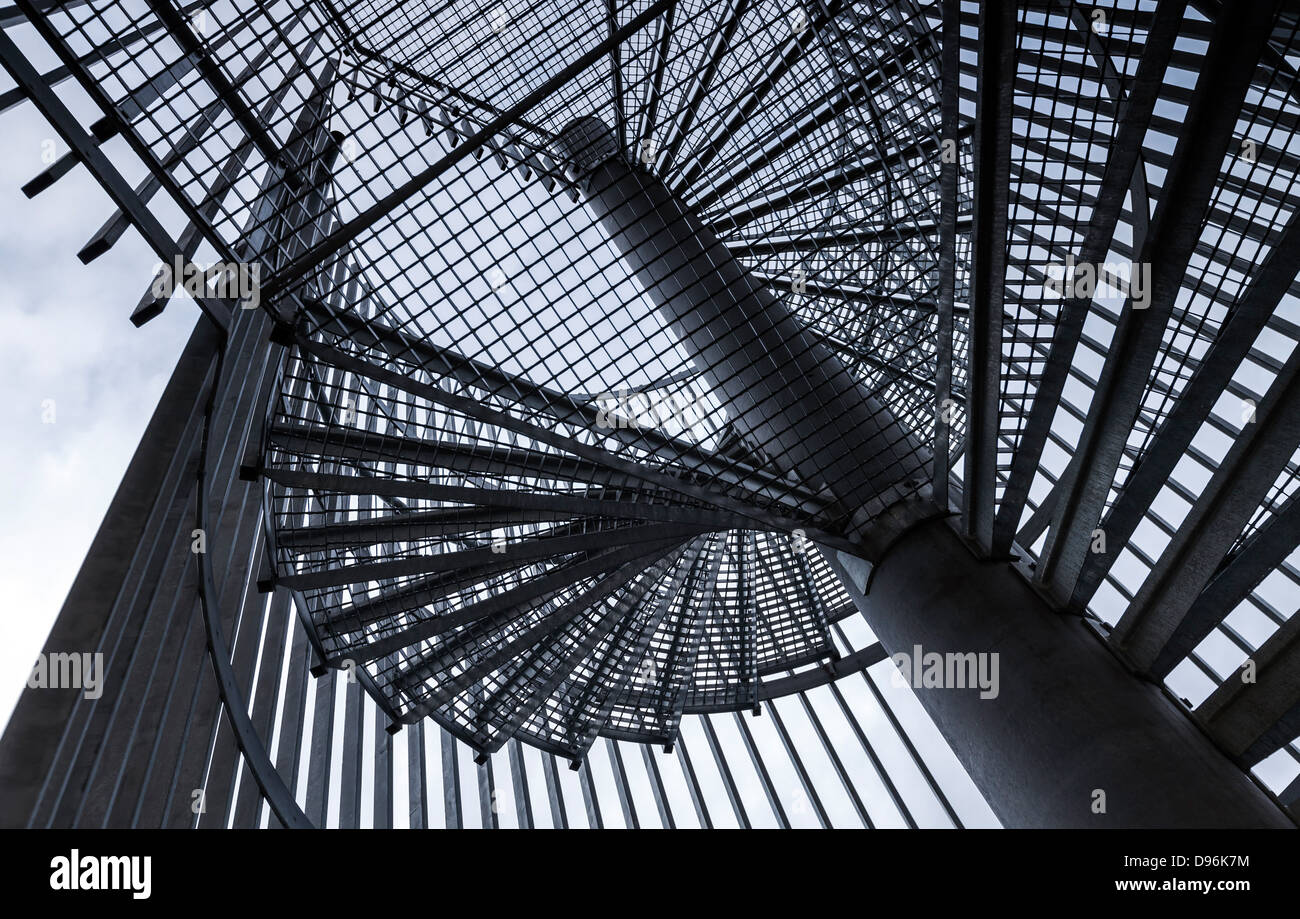 Metal modern spiral staircase details above blue sky Stock Photo