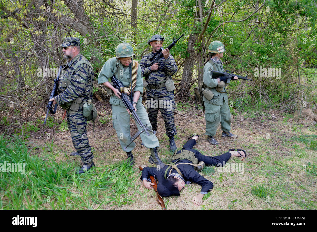 US soldiers stand over a dead Viet Cong soldier in a reenactment of the Vietnam War that was held in Glendale, Md Stock Photo