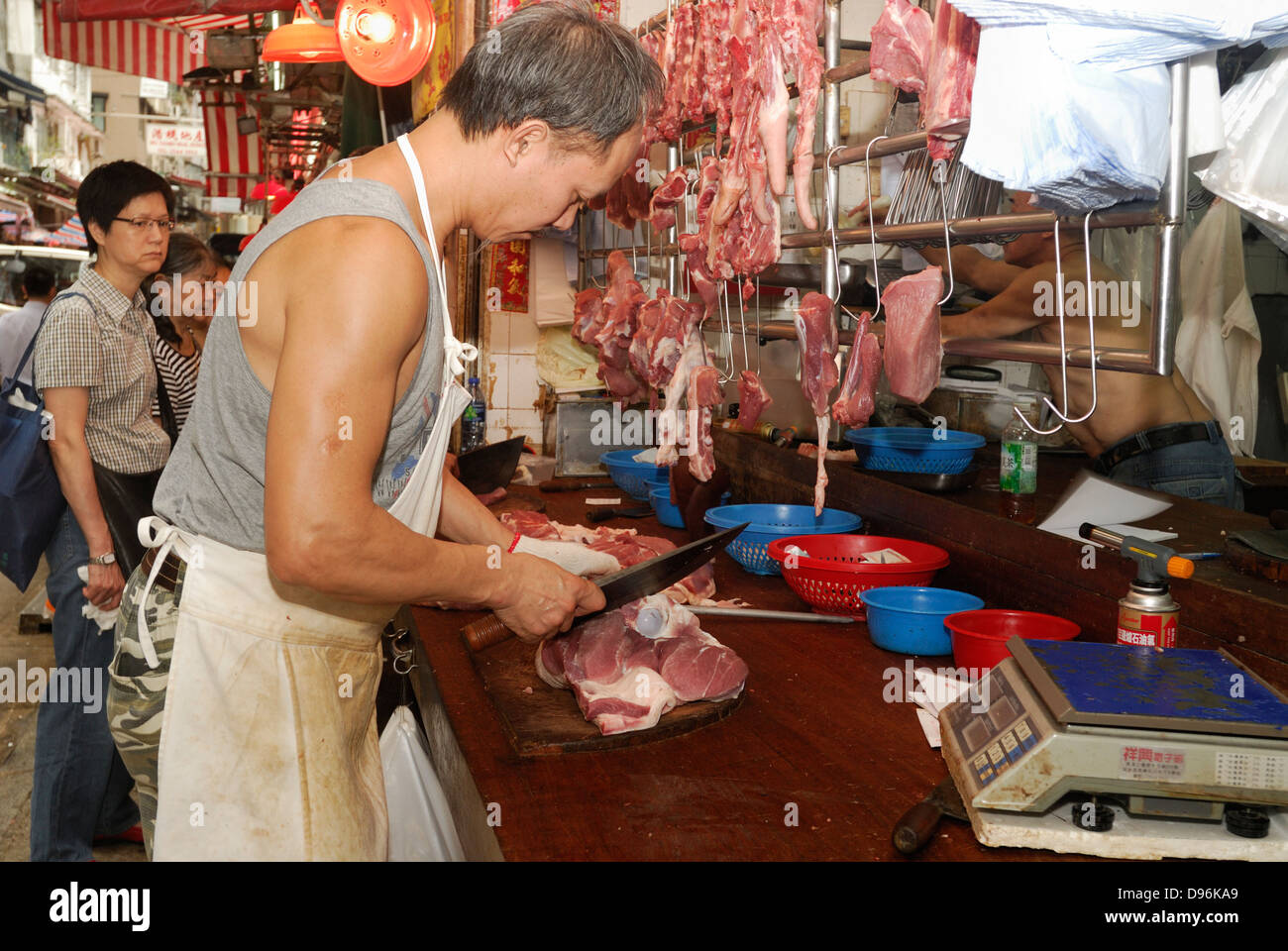 A Chinese butcher prepares meat in his shop in a village in China