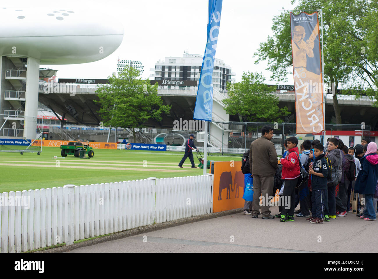 Schoolchildren gather on the Nursery End at Lord's cricket ground on a school trip Stock Photo